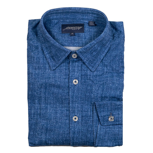 A folded blue chambray shirt with signature square buttons on the cuff, collar stays, and a tailored collar.